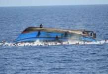 Tug boat piloting barge load of containers sinks at Tin-can port